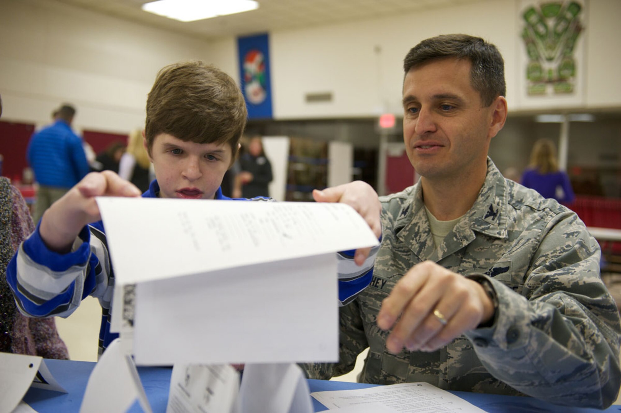 Sam Murphey, 13, and father Air Force Col. Bill Murphey, 715th Air Mobility Operations Group commander, build a paper tower in and Adventure Club exercise, Feb. 10, for Central Middle School of Science’s military appreciation banquet. (U.S. Air Force photo/David Bedard)