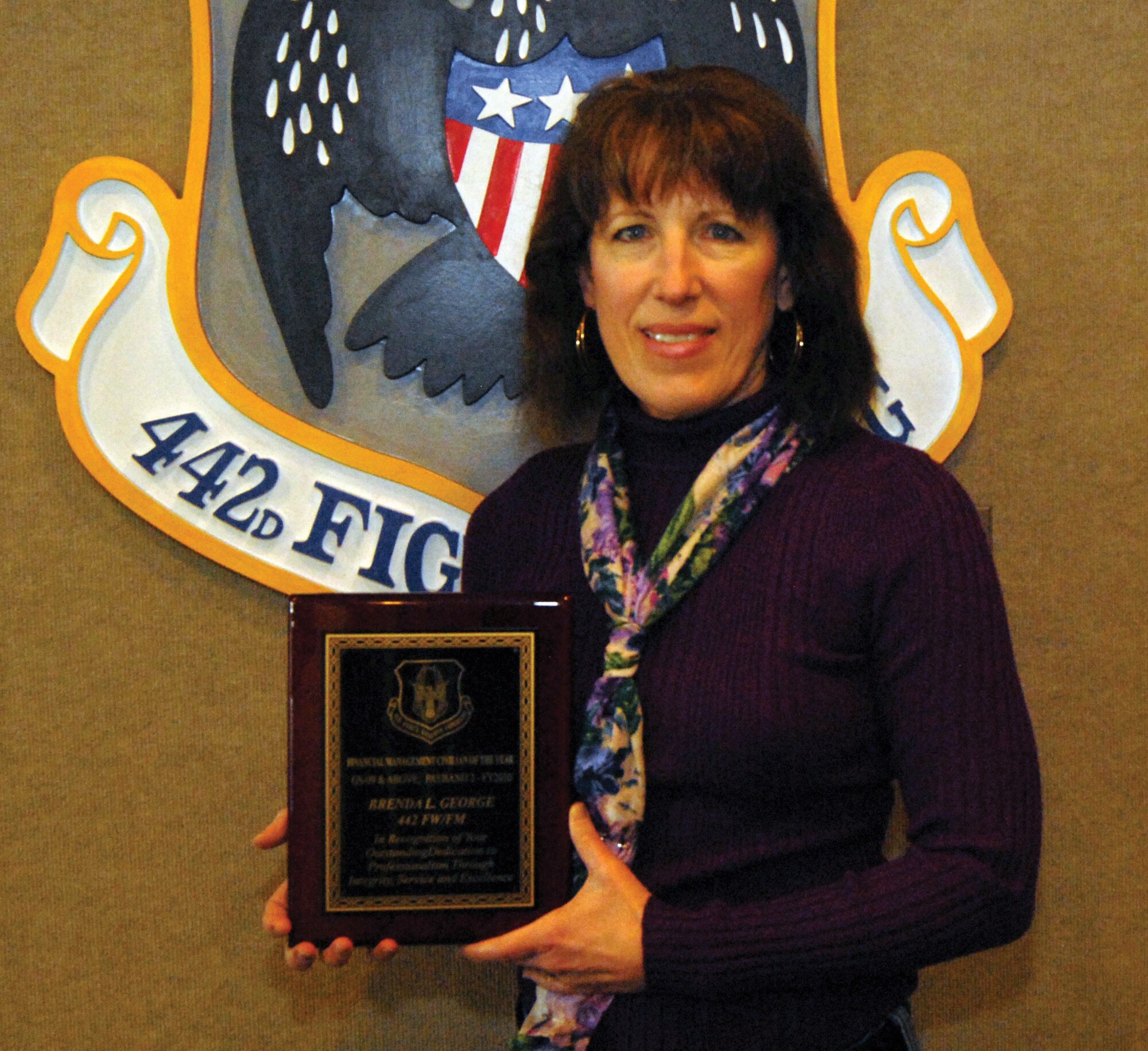 Ms. George received the Air Force Reserve Command Financial Management Civilian of the Year Award for general-schedule 09 and above; payband 2 employees for fiscal year 2010 for her outstanding dedication to professionalism through integrity, service before self and excellence. The award was presented to Ms. George by the 442nd Fighter Wing commander, Col. Eric S. Overturf, Feb. 11 at Whiteman AFB, Mo. 

Ms. George joined the civil-service ranks as a communications squadron resource advisor while overseas as a dependent spouse. She said originally, it was just her intention to maintain speady employment while living as an overseas dependent, but it has resulted in a career in civil service. 

"I have always strived to be one of the go-to people when someone needs assistance," she said. "If I do not have the answer, I will get one. I also support the financial management-function and our wing commander to the best of my ability."

Ms. George has a bachelor of arts degree in accounting from the University of Missouri in Columbia, Mo. and numerous hours of continuing education in finance, budgeting and contracting, since joining the Department of Defense. 

"(The most rewarding aspect of my job is) being recgonized as a knowledgeable and dependable team player by those I work closely with both inside and outside the 442nd Fighter Wing," she said. 

Ms. George is responsible for funding in areas of unit-training assemblies, Air Force Training Periods, Reserve Management Periods and bonuses as well as orders for annual tour, formal schools, basic training, manday support and unit deployments. 

"We constantly juggle numerous requirements at the unit and wing levels in an effort to procure dollars needed to complete each and every mission," she said. 

In her free time, she enjoys swimming, playing volleyball and spending time with her family, to include her 20-year-old daughter Kacee, who is currently a student at Emporia State University in Kansas. (U.S. A