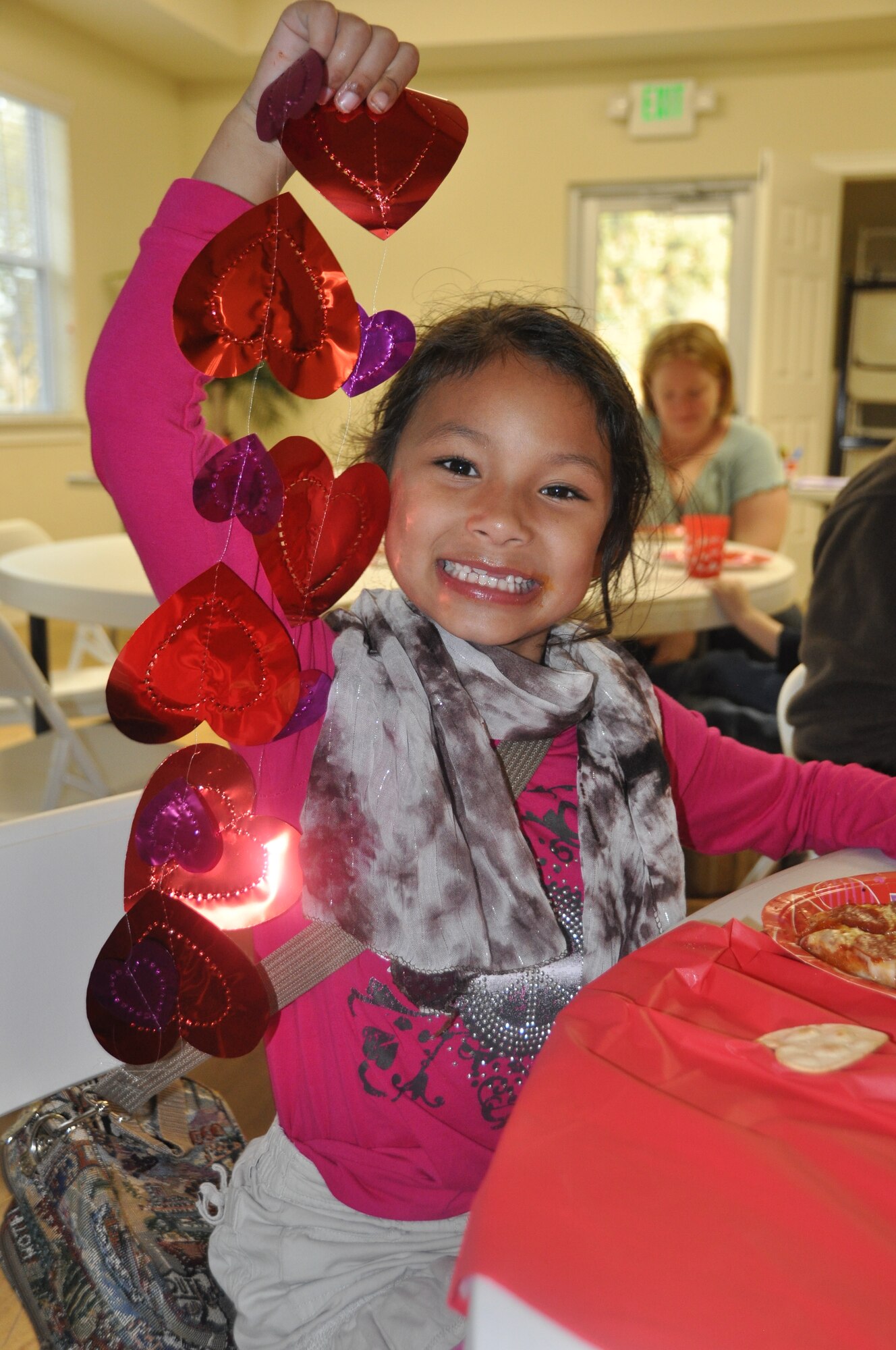 Keona Mommaerts, daughter of Tech. Sgt. Jason Mommaerts, enjoys pizza and valentine’s decorations at the special needs Valentine’s Day party at the Balfour Beatty Community Center Feb. 11. 