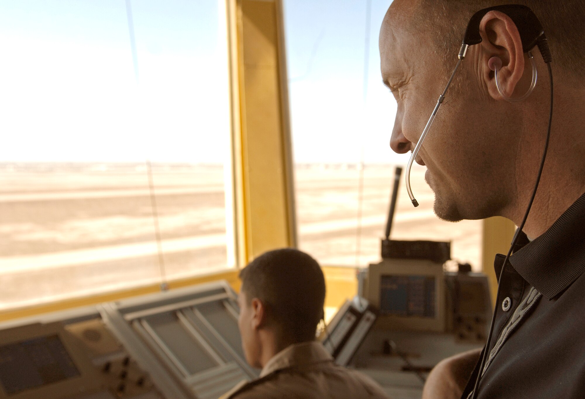 Kenneth Chappell directs airfield traffic with the help of Iraqi air force trainees Feb. 3, 2011. Mr. Chappell is the team lead contractor for Iraq Training and Advisory Mission-Air's air traffic control tower training (U.S. Air Force photo/Tech. Sgt. Jason Lake)