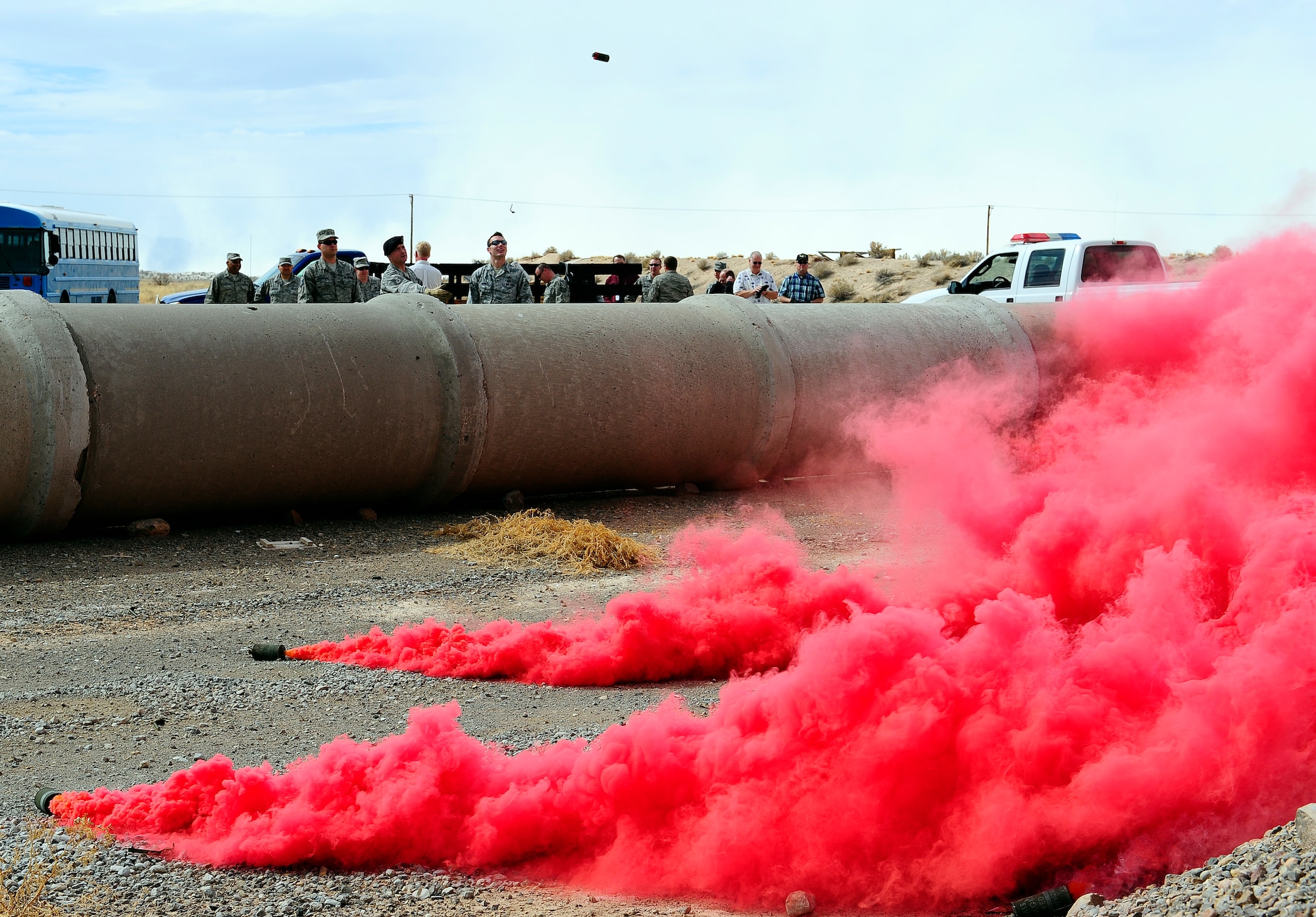 HOLLOMAN AIR FORCE BASE, N.M. -- Exercise Evaluation Team members practice deploying M18 smoke grenades Feb. 17, 2011. The Holloman Plans and Programs Office is required to keep team members proficient in order to conduct base exercises.  (U.S. Air Force photo by Tech. Sgt. Chris Flahive/Released)