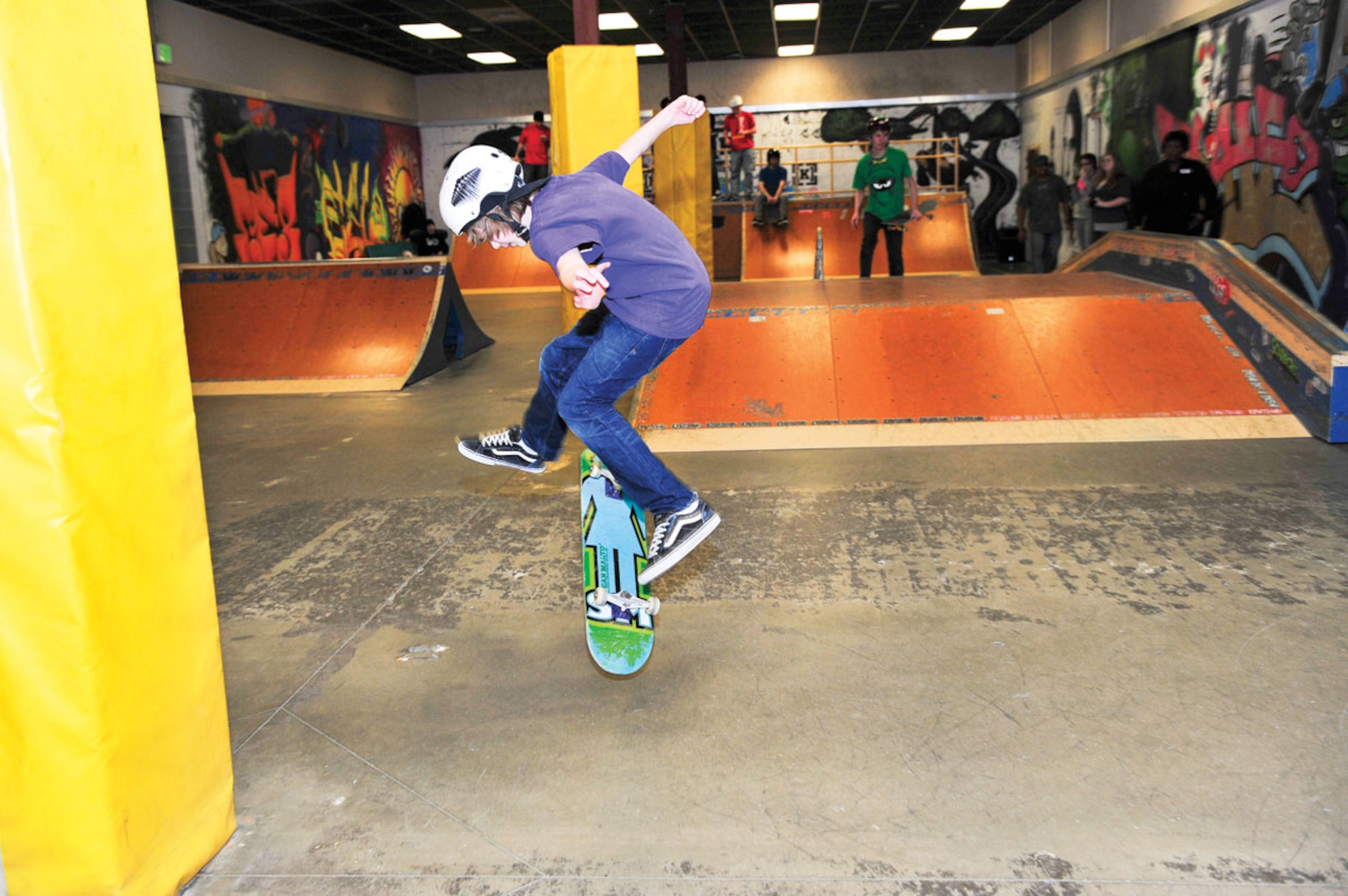 Matthew Nelms, 12, attempts a kickflip during the skate demonstration, Feb 12. (U.S. Air Force photo/Senior Airman Kristin High)