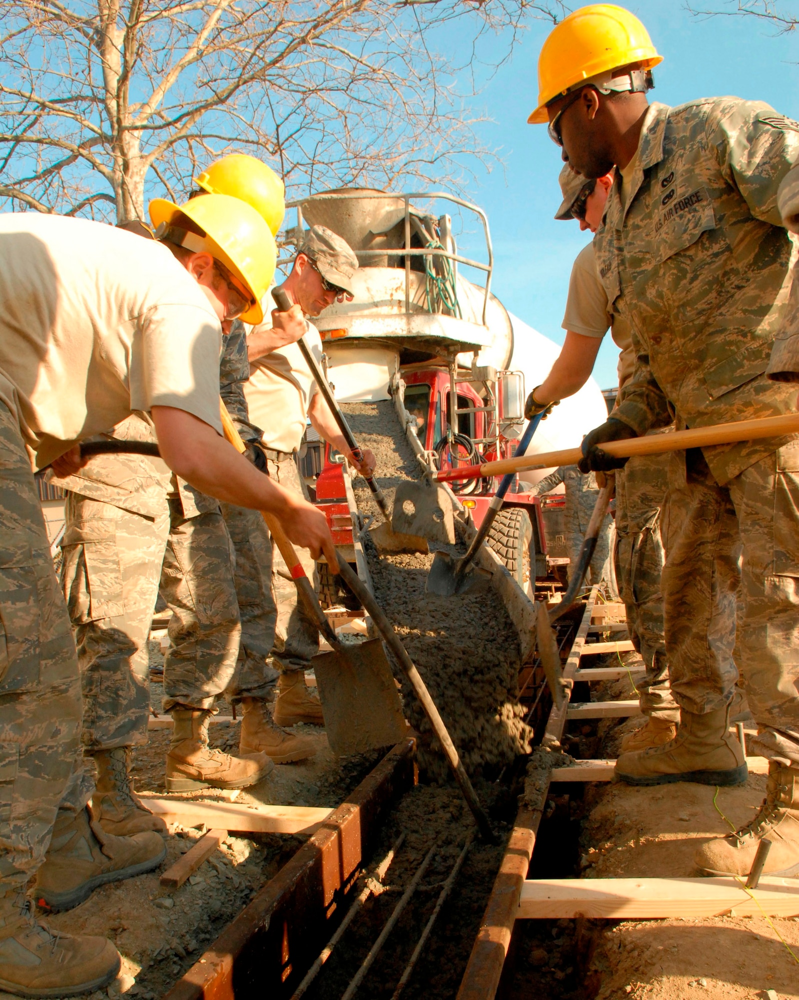 Members of the 436th Civil Engineer Squadron pour a concrete footer during the Prime Base Emergency Engineer Force training project Feb. 18, 2011, at Dover Air Force Base, Del. (U.S. Air Force/Airman 1st Class Matthew Hubby)