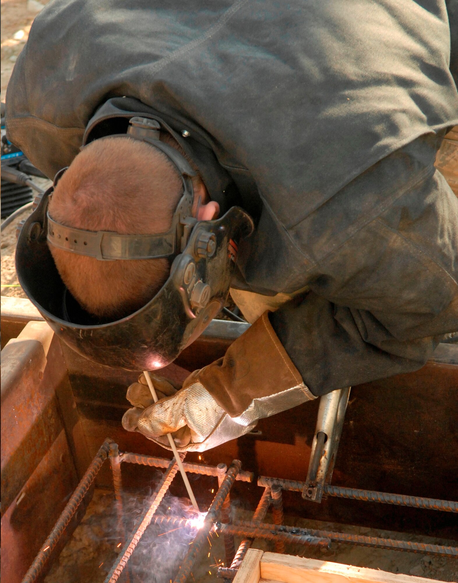 Airman 1st Class Adam Monoski, 436th Civil Engineer Squadron, welds anchors for a concrete footer during the Prime Base Emergency Engineer Force training project Feb. 18, 2011 at Dover Air Force Base, Del. (U.S. Air Force/Airman 1st Class Matthew Hubby)