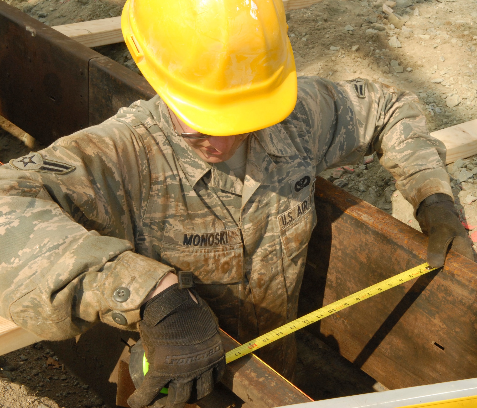 Airman 1st Class Adam Monoski, 436th Civil Engineer Squadron, ensures the form for a concrete footer is evenly spaced during the Prime Base Emergency Engineer Force training project Feb. 18, 2011 at Dover Air Force Base, Del.  (U.S. Air Force/Airman 1st Class Matthew Hubby)