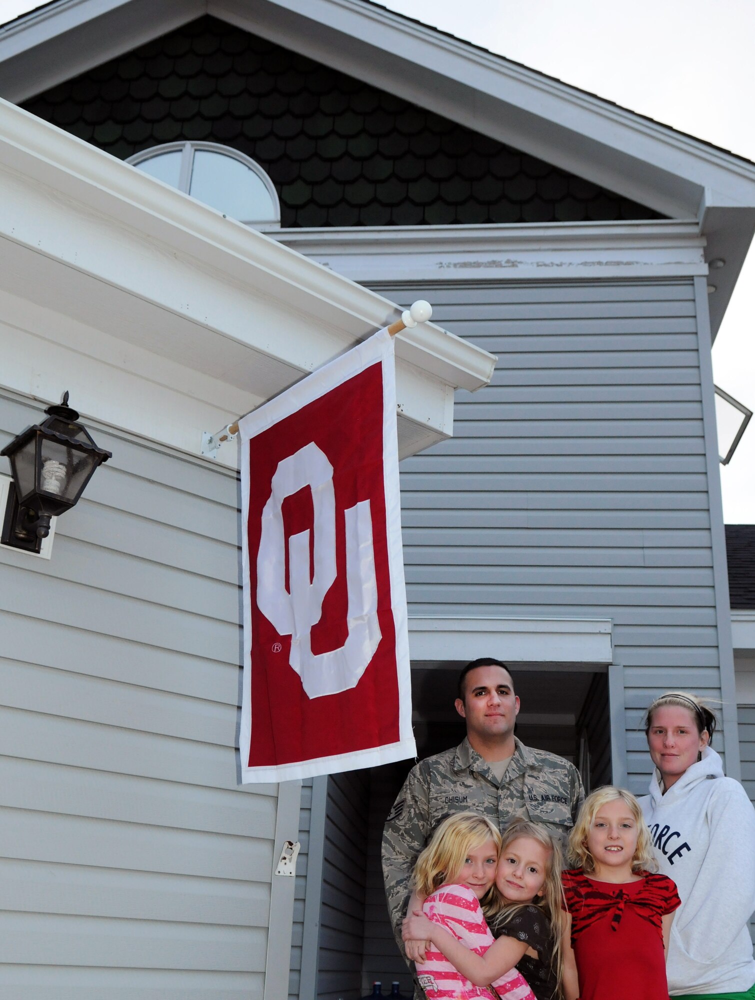 The family of Staff Sgt. Bill Chisum, 90th Medical Support Squadron, pose outside of their quarters on Wyodak Loop on F. E. Warren Air Force Base, Wyo. Chisum’s daughters are Trinity, age 9; Tessa, age 4 and Destiny, age 9. His wife, Jami, is on the right. (U.S. Air Force photo by R.J. Oriez)