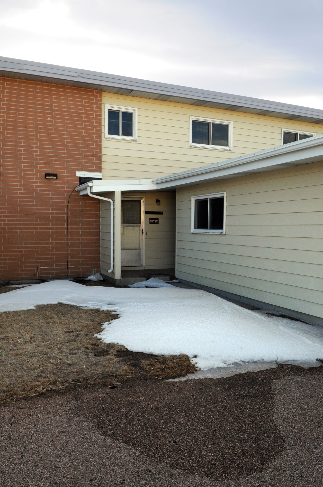 Snow lies undisturbed on the sidewalk of an unoccupied unit in the Capehart Housing area on Bannock Rd on F. E. Warren Air Force Base, Wyo. This unit, and the others in the area which were built in the 1960’s, is slated to be torn down and replaced with new housing units. (U.S. Air Force photo by R.J. Oriez)