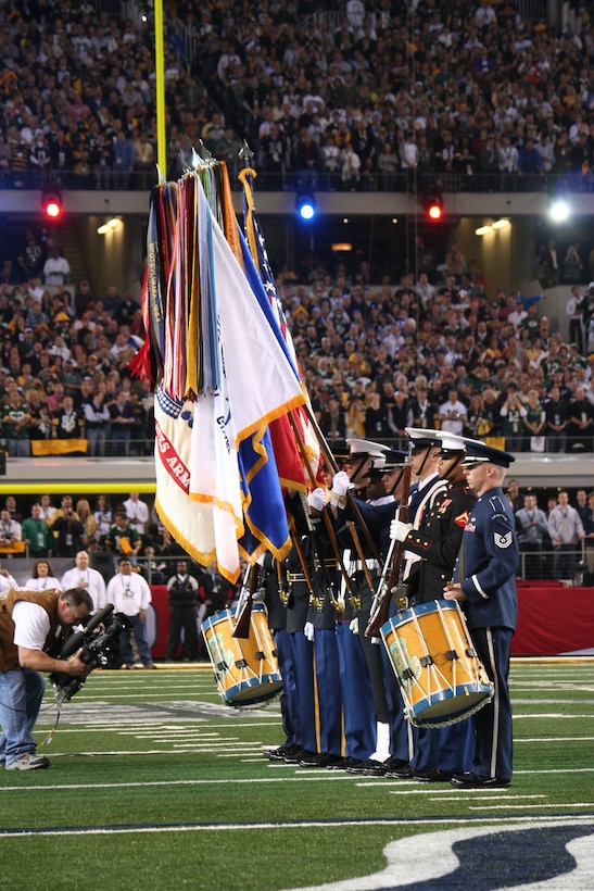 Master Sgt. Chris Martin and Tech. Sgt. Nathan Lavy, percussionists in the Ceremonial Brass, march into position on the field for the National Anthem during Super Bowl XLV at Cowboys Stadium in Arlington, Tex., on Sunday, Feb. 6.  This is the second consecutive year that the Band has taken part in the National Anthem at the Super Bowl. The United States Air Force Honor Guard—stationed at Joint Base Anacostia-Bolling with The USAF Band—was also part of the joint service formation.  (U.S. Air Force photo/SSgt Christopher Bolen)