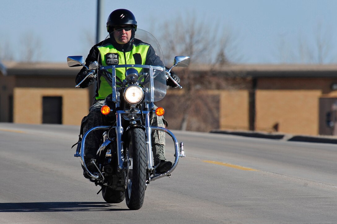 Chief Master Sgt. Brian Lavoie, 28th Bomb Wing command chief, wears personal protective equipment while riding his motorcycle on Ellsworth Air Force Base, S.D., Feb. 16, 2011.  Proper PPE consists of: head, eye and foot protection, eye protection, protective clothing such as pants and long sleeve shirts and garment and motorcycle visibility enhancers. (U.S. Air Force photo/Staff Sgt. Marc I. Lane)