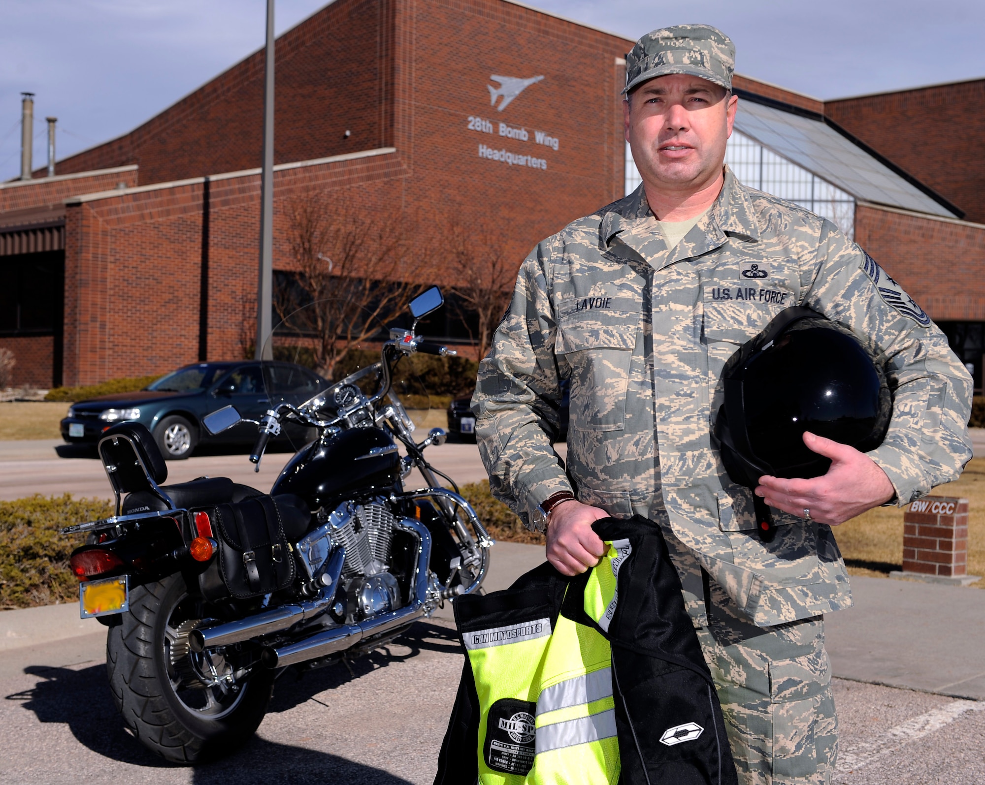 Chief Master Sgt. Brian Lavoie, 28th Bomb Wing command chief, stands in front of his motorcycle holding personal protective equipment on Ellsworth Air Force Base, S.D., Feb. 16, 2011.  As an avid motorcycle rider, Chief Lavoie encourages all Ellsworth Airmen and Air Force civilians to register in the Motorcycle Unit Safety Tracking Tool by contacting their unit safety representative. (U.S. Air Force photo/Staff Sgt. Marc I. Lane)