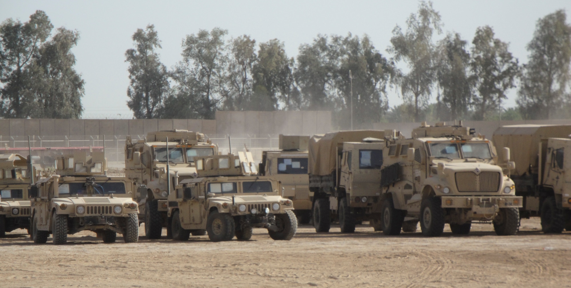 Mine Resistant Ambush Protected vehicles, along with M119 Humvee?s, and tractor-trailers also known as 915?s, getting ready for a mission outside of a forward operating base in Iraq.