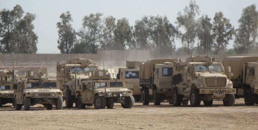 Mine Resistant Ambush Protected vehicles, along with M119 Humvee's, and tractor-trailers also known as 915's, getting ready for a mission outside of a forward operating base in Iraq. 
