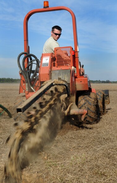 MOODY AIR FORCE BASE, Ga. -- Senior Airman Joshua Beach, 23rd Civil Engineer Squadron water and fuel system maintenance craftsman, uses a trencher to dig a trench Feb. 15. The trench must be approximately 18 inches deep to ensure the sewage line stays covered. (U.S. Air Force photo/Airman 1st Class Douglas Ellis)(RELEASED)
