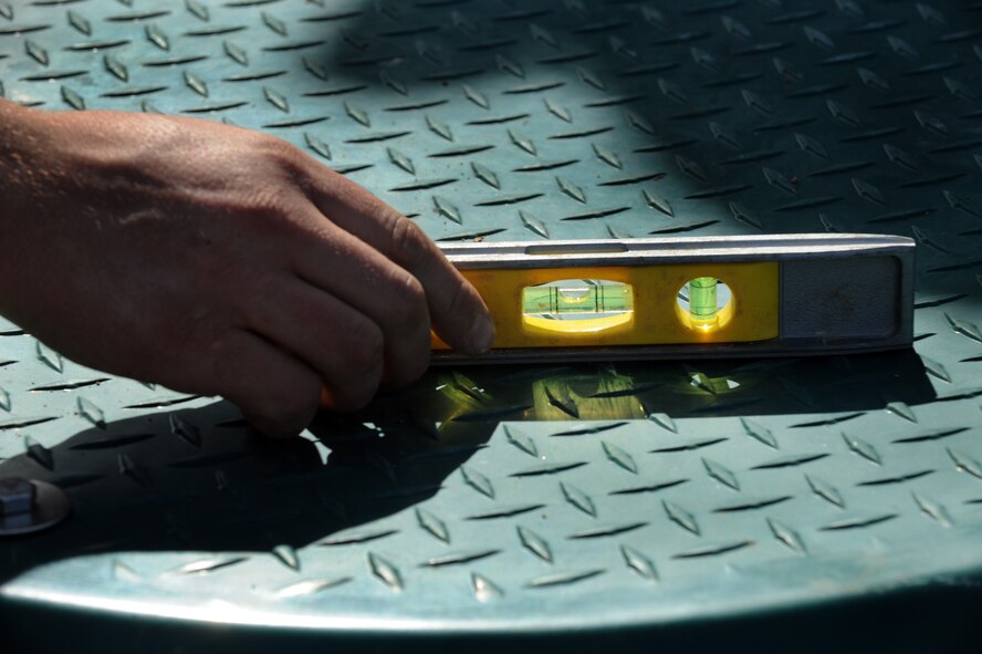 MOODY AIR FORCE BASE, Ga. -- Senior Airman Joshua Beach, 23rd Civil Engineer Squadron water and fuel system maintenance craftsman, checks to see if a lift station is level Feb. 15. This lift station was put in to prevent sewage lines from backing up. (U.S. Air Force photo/Airman 1st Class Douglas Ellis)(RELEASED)
