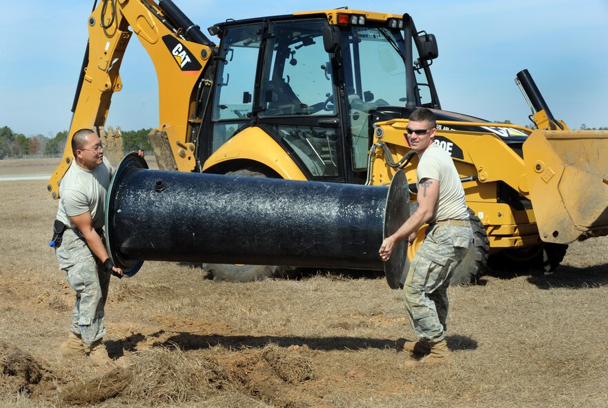 MOODY AIR FORCE BASE, Ga. -- Staff Sgts. Parker Yusko (left) and Cecil Barnhill, 23rd Civil Engineer Squadron water and fuel system maintenance craftsmen, carry a lift station Feb. 15. The lift station will collect and transfer sewage to the main sewer line. (U.S. Air Force photo/Airman 1st Class Douglas Ellis)(RELEASED)
