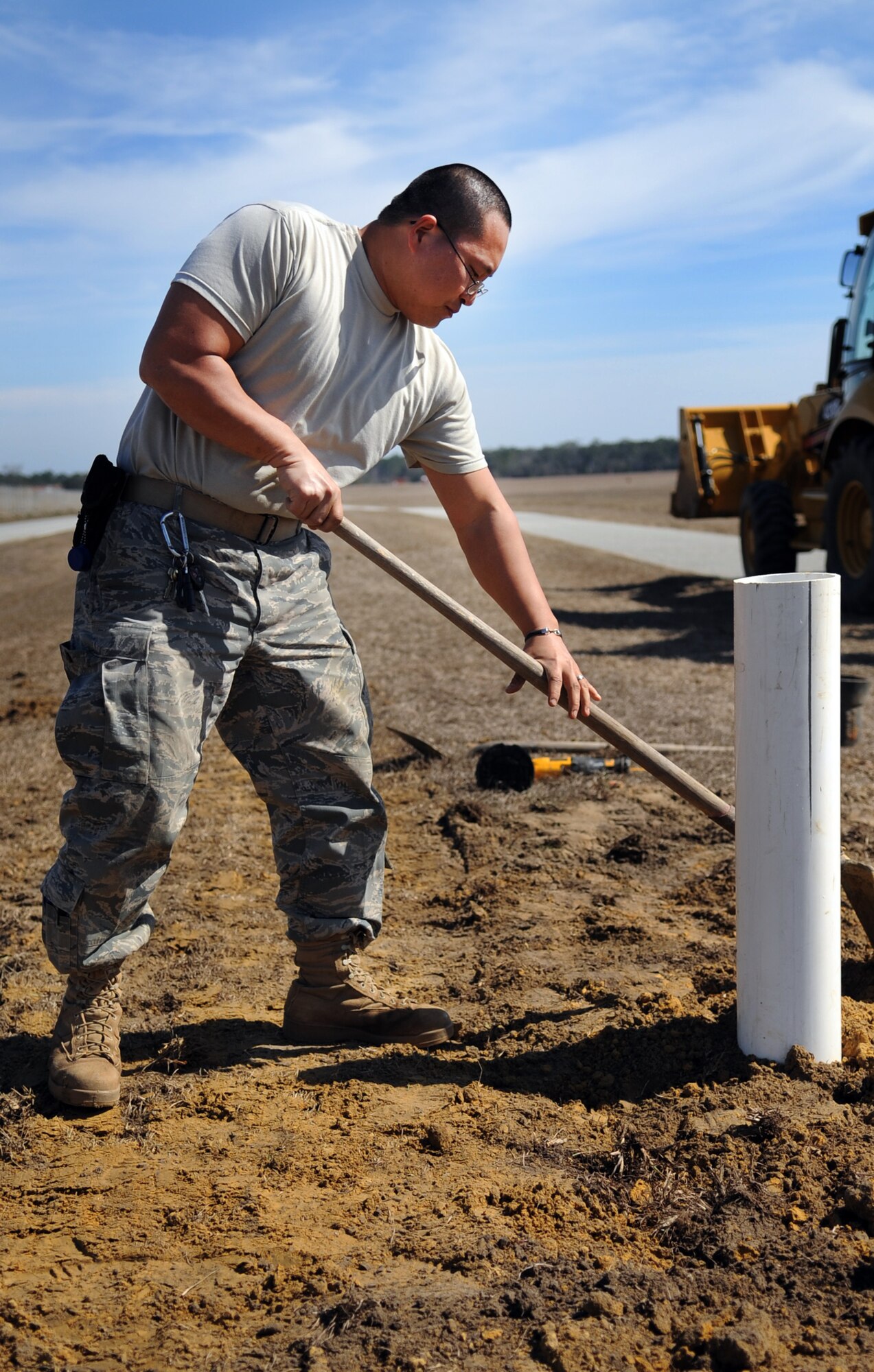 MOODY AIR FORCE BASE, Ga. -- Staff Sgt. Parker Yusko, 23rd Civil Engineer Squadron water and fuel system maintenance craftsman, levels dirt after burying a trench Feb. 15. The trench was made for a sewage line that would connect the lift station to the main sewage pipe. (U.S. Air Force photo/Airman 1st Class Douglas Ellis)(RELEASED)
