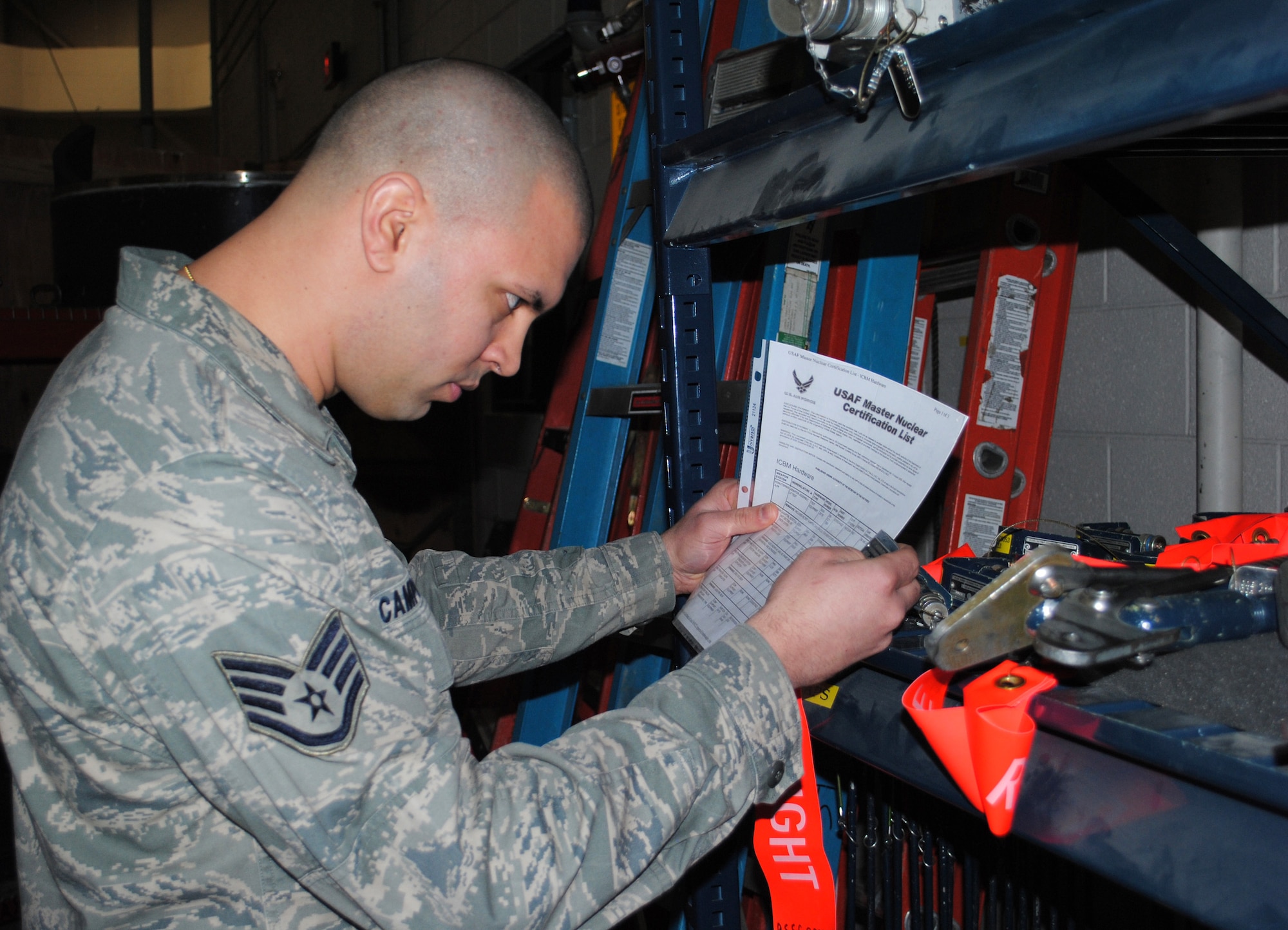 Staff Sgt. Armando Campos Rivera, 341st Missile Operations Squadron nuclear certified equipment monitor, performs his daily duty of comparing equipment to the Master Nuclear Certification List.  The MNCL is the sole authority for determining certification status of NCE.  (U.S. Air Force photo/Airman Cortney Hansen)