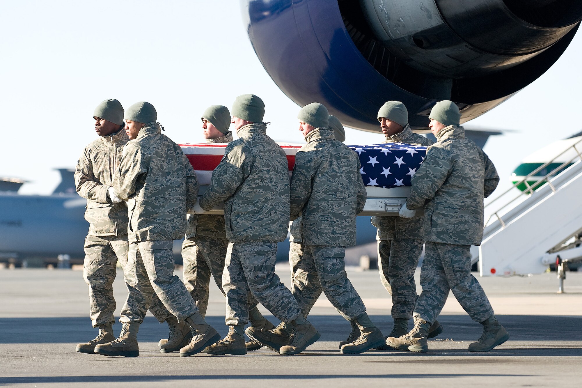 An Air Force carry team transfers the remains of Airman 1st Class Christoffer P. Johnson Feb. 19, 2011, at Dover Air Force Base, Del. Airman Johnson was assigned to the 423rd Security Forces Squadron at Royal Air Force Alconbury, England. (U.S. Air Force photo/Roland Balik)