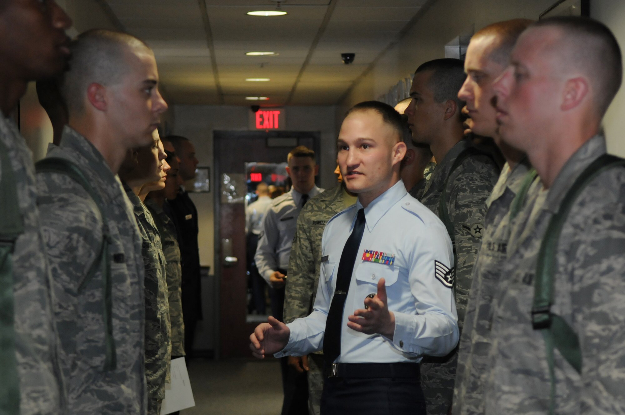 Staff Sgt. Christopher Cenatiempo, training instructor in The U.S. Air Force Honor Guard, directs the incoming airman about dorm procedures and rules Feb. 14 at Joint Base Anacostia-Bolling, Washington, D.C. The new trainees complete eight weeks of technical training before they are qualified to participate in the honor guard’s mission at Arlington National Cemetery. (U.S. Air Force photo by Senior Airman Christopher Ruano)