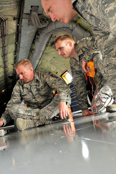 185th Air Refueling Wing Crew Chief, Master Sgt. Ron Hanson (left) works with Tech. Sgt. Ryan Willis an electric and environmental specialist and Tech. Sgt. Paul Hines a jet engine mechanic with the 185th Air Refueling Wing (ARW), Sioux City, Iowa, Iowa Air National Guard. The group is trouble shooting a faulty battery with an on a KC-135 Tanker while on temporary duty at the Royal Australian Air Force (RAAF) Base, Williamtown, New South Wales, Australia, on February 22, 2011. The 185th ARW is participating in a joint flight exercise, "Sentry Down Under", refueling F-16C and Australian F-18 Fighter Jets in while in Australia. (USAF Photo/ Tech. Sgt. Oscar M. Sanchez-Alvarez)