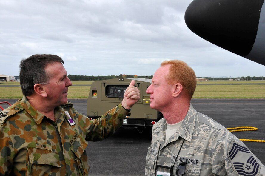 Flight Sergeant Allistair Free (left) fire controller with the Royal Australian Air Force (RAAF), discusses emergency fire procedures for the KC-135 Tanker, with Chief Master Sgt.  Mark Wankum, Aircraft Maintenance Branch Chief, with the 185th Air Refueling Wing(ARW) Sioux City, IA., Iowa Air National Guard, at the Royal Australian Air Force (RAAF) Base, in Williamtown, New South Wales, Australia, on February 22, 2011. The 185th ARW is participating in a joint flight exercise, "Sentry Down Under", refueling F-16C and F-18 Fighter Jets, with the RAAF.
(USAF Photo/ Tech. Sgt. Oscar M. Sanchez-Alvarez)
