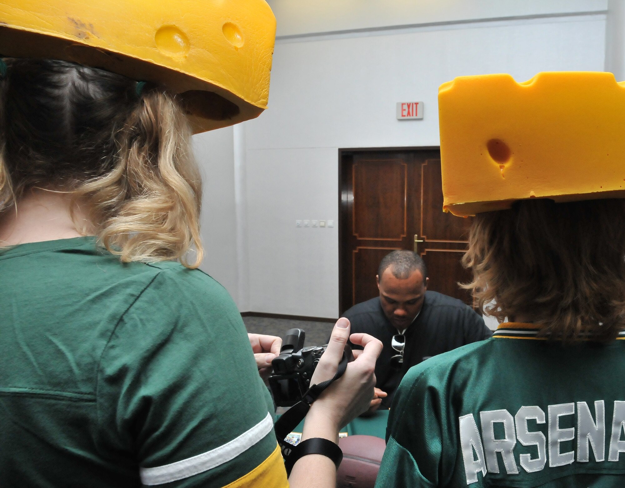 Fans wait for a photo and autograph from members of the National Football league team the Green Bay Packers during their visit to Incirlik Air Base, Turkey, Feb. 12, 2011. The trip was organized by Navy Entertainment and the 39th Force Support Squadron as part of the team’s “Tundra Tour.” Super Bowl XLV champions Jarrett Bush, Derrick Martin, William Henderson, Frank Zombo, Nick McDonald, and Daryn Colledge, as well as Pepper Burruss, the head athletic trainer for the Packers, conducted a behind-the-scenes presentation and an autograph session during their visit to the base.  (U.S. Air Force photo by Staff Sgt. Alex Montes)