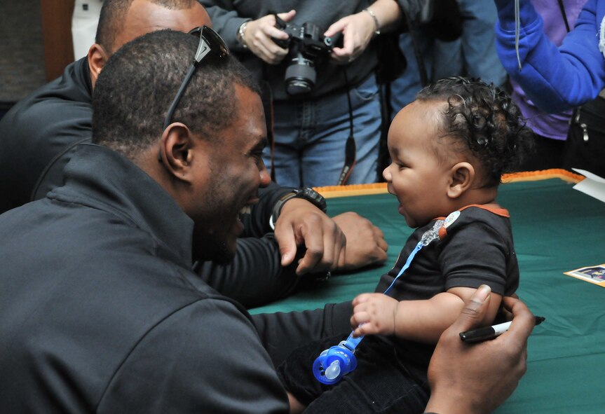 Derrick Martin, a safety from the National Football League team the Green Bay Packers, meets with Airmen and their families during a recent visit to Incirlik Air Base, Turkey, Feb. 12, 2011. The trip was organized by Navy Entertainment and the 39th Force Support Squadron as part of the team’s “Tundra Tour.” Super Bowl XLV champions Jarrett Bush, Derrick Martin, William Henderson, Frank Zombo, Nick McDonald, and Daryn Colledge, as well as Pepper Burruss, the head athletic trainer for the Packers, conducted a behind-the-scenes presentation and an autograph session during their visit to the base.   (U.S. Air Force photo by Staff Sgt. Alex Montes)