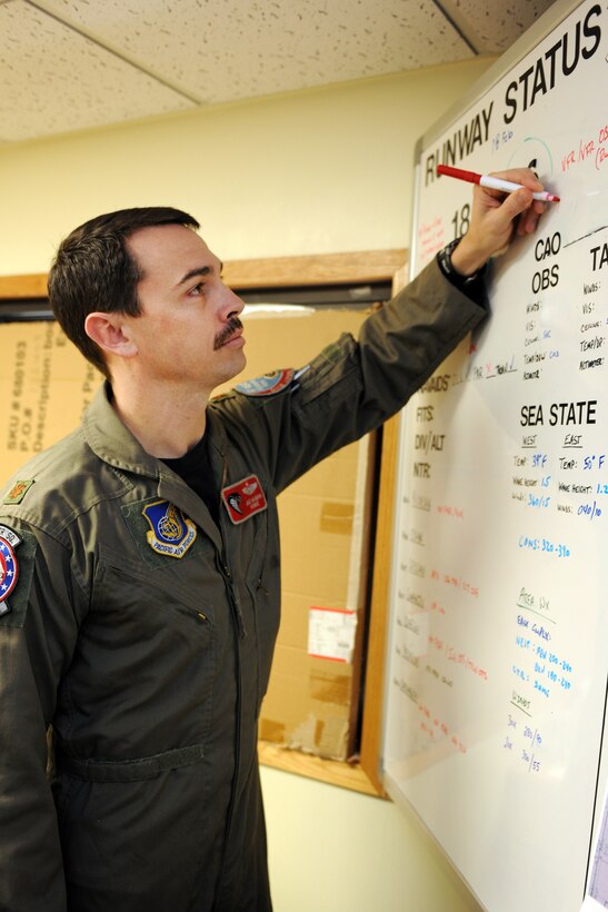KUNSAN AIR BASE, Republic of Korea -- Maj. Mike McGinn, 134th Expeditionary FIghter Squadron pilot, updates an operational status board with current information here Feb. 22. The 134th EFS consists of service members who deploy to the ROK on 30- and 60-day rotations. (U.S. Air Force photo/Tech. Sgt. Jonathan Pomeroy) 