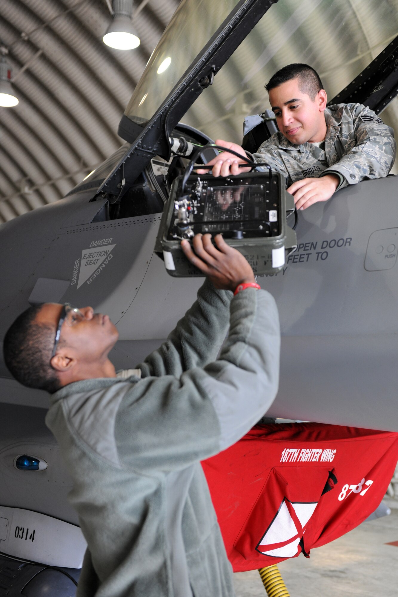 KUNSAN AIR BASE, Republic of Korea -- Airman 1st Class Deymond Sankey and Senior Airman Laurence Urrutia, 134th Expeditionary Fighter Squadron members, secure a flight control test set while performing routine maintenance on an F-16 Fighting Falcon here Feb. 22. Ensuring aircraft are fully operational is a vital part to the mission the 134th EFS performs daily. (U.S. Air Force photo/Tech. Sgt. Jonathan Pomeroy) 