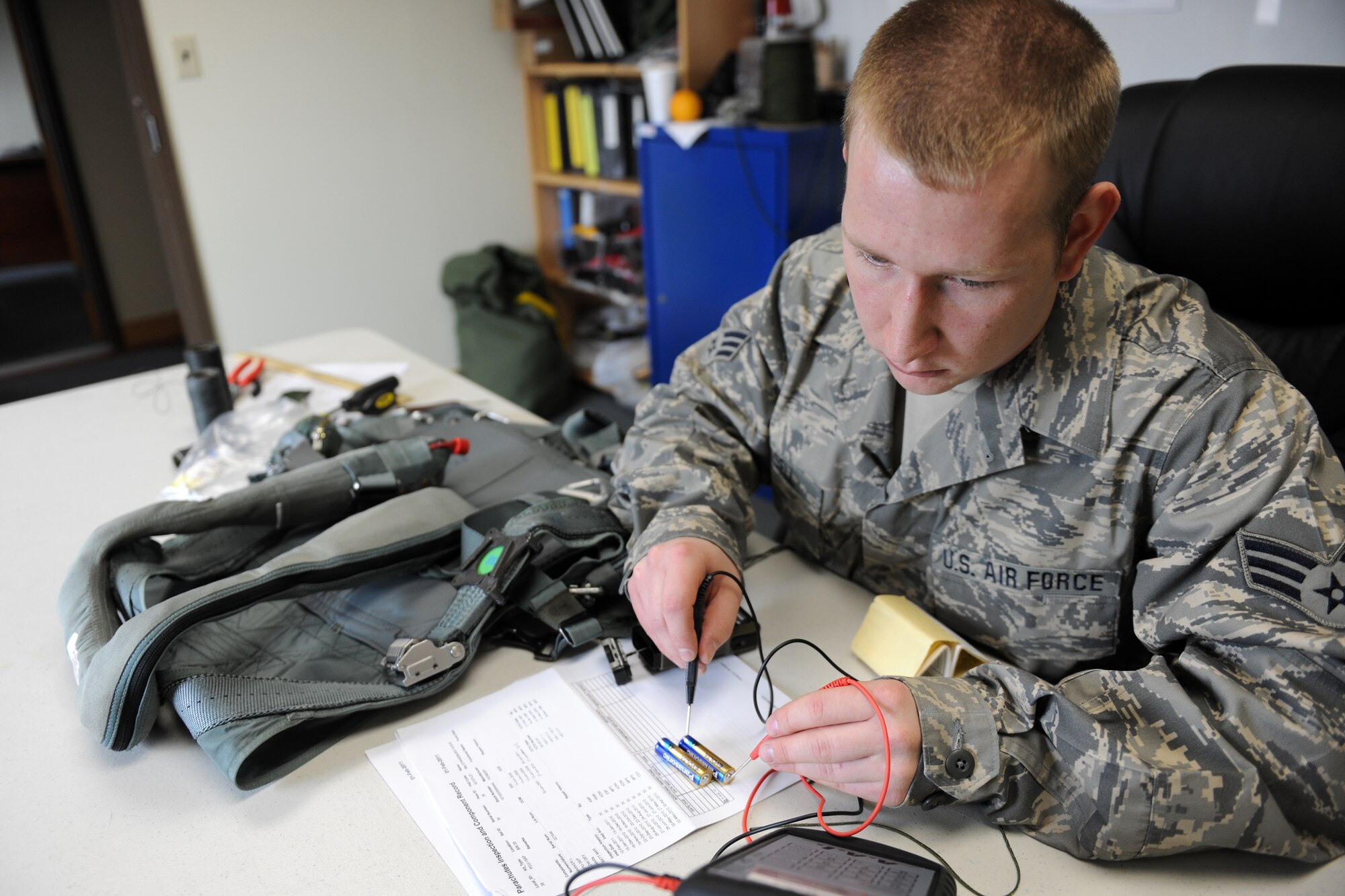 KUNSAN AIR BASE, Republic of Korea -- Senior Airman Tyler Russell, 134th Expeditionary Fighter Squadron member, uses an Aviation Life Support Equipment Tester to check the voltage of batteries used on a strobe light to verify they give out the correct amount of power when the light is in use here Feb. 22. Performing routine safety compliance checks on pilot equipment is just one of the many ways the 134th EFS ensures mission success. (U.S. Air Force photo/Tech. Sgt. Jonathan Pomeroy) 
