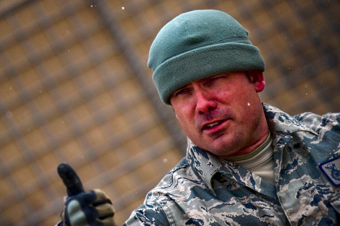 U.S. Air Force Staff Sgt. Michael Stevens gives a thumbs up to indicate that Karo, his military working dog, has positively sniffed out explosive materials on Forward Operating Base Lagman, Afghanistan, Feb. 18, 2011. 