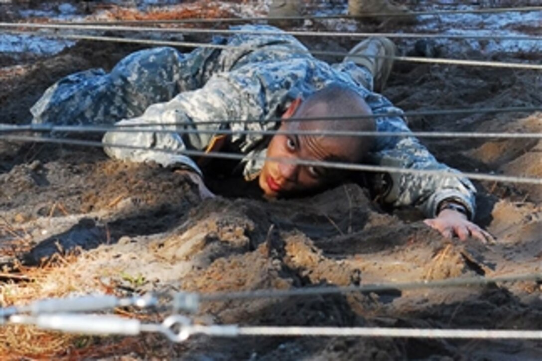 A U.S. Army National Guardsman crawls under an obstacle during air assault school at Camp Blanding Joint Training Center, Fla., on Feb. 15, 2011.  More than 200 soldiers and airmen participated in the two-week course, which is focused on teaching combat assault operations involving helicopters.  