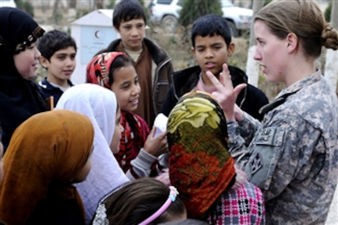 U.S. Army 1st Lt. Rebecca Wagner counts with the Afghan children of the Red Crescent Society orphanage and school as the 4th Calvary Aviation Brigade delivers school supplies, clothing items and toys on Feb. 12, 2011.  Wagner is effects coordinator and female engagement team officer in charge, Headquarters and Headquarters Company, 4th Infantry Division's, 4th Combat Aviation Brigade, International Assistance Security Force.  