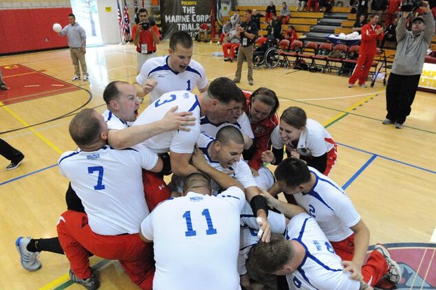 MARINE CORPS BASE CAMP PENDLETON, Calif. (Feb. 26)- Battalion West celebrates after clinching the final point that earned them the title of sitting volleyball champions during the 2011 Marine Corps Trials Feb. 26 here.