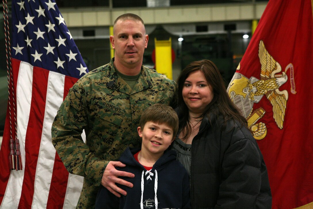 1st Sgt. Anthony J. Pompos, first sergeant for Ordnance Maintenance Company, 2nd Maintenance Battalion, 2nd Marine Logistics Group, poses for a photo with his family during a ceremony aboard Camp Lejeune, N.C., Feb. 23, 2011, where he was awarded the Bronze Star Medal. Pompos joins this elite group of service members for his heroic service in connection with combat operations against the enemy while serving as first sergeant for Bravo Company, 1st Battalion, 6th Marine Regiment, Marine Expeditionary Brigade - Afghanistan, on Feb. 13, 2010, in support of Operation Enduring Freedom. (U.S. Marine Corps photo by Pfc. Franklin E. Mercado)