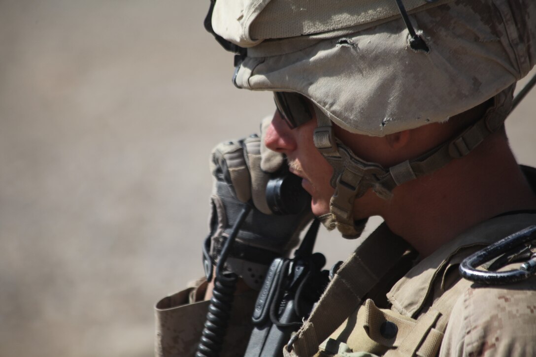 U.S. Marine Corps Cpl. Mitchel R. Atkins, squad leader for 2nd Squad, 1st Platoon, Company L, Battalion Landing Team 3/8, 26th Marine Expeditionary Unit, Regimental Combat Team 8, puts his Marines into position over the radio during a security patrol near Combat Outpost Ouellette in Helmand province, Afghanistan, Feb. 23, 2011. Elements of the 26th Marine Expeditionary Unit deployed to Afghanistan to provide regional security in Helmand province in support of the International Security Assistance Force.
