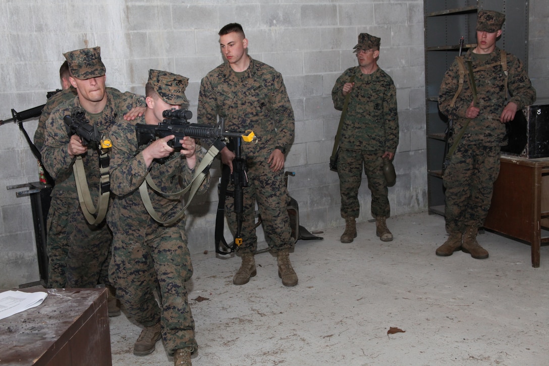 2nd Low Altitude Air Defense Marines demonstrate proper room clearing techniques for the Marines of Battery B, 2nd LAAD Battalion in the Military Operations on Urban Terrain town aboard Marine Corps Base Camp Lejeune, N.C., Feb. 23.