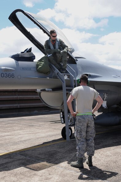 1st Lt. Nick Barney (left), F-16 pilot from the 132nd Fighter Wing (132FW), Des Moines, Iowa, prepares for launch on the flight line of the Royal Australian Air Force (RAAF) Base, Williamtown, Australia during joint flying mission, "Sentry Down Under", on February 23, 2011; Staff Sgt. Cory Weaver (right), 132FW Crew Chief, assists.  (US Air Force photo/Staff Sgt. Linda E. Kephart)(Released)