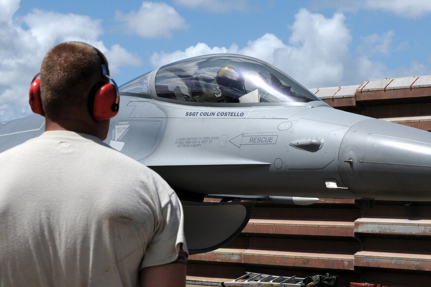 Tech. Sgt. Colin Costello, Crew Chief for the 132nd Fighter Wing (132FW), Des Moines, Iowa, waits to marshal an F-16 C+ aircraft to the runway of the Royal Australian Air Force (RAAF) Base, Williamtown on February, 23, 2011.  The 132FW and RAAF are currently engaged in Dissimilar Air Combat Training mission, "Sentry Down Under", in Australia.  (US Air Force photo/Staff Sgt. Linda E. Kephart)(Released)   
