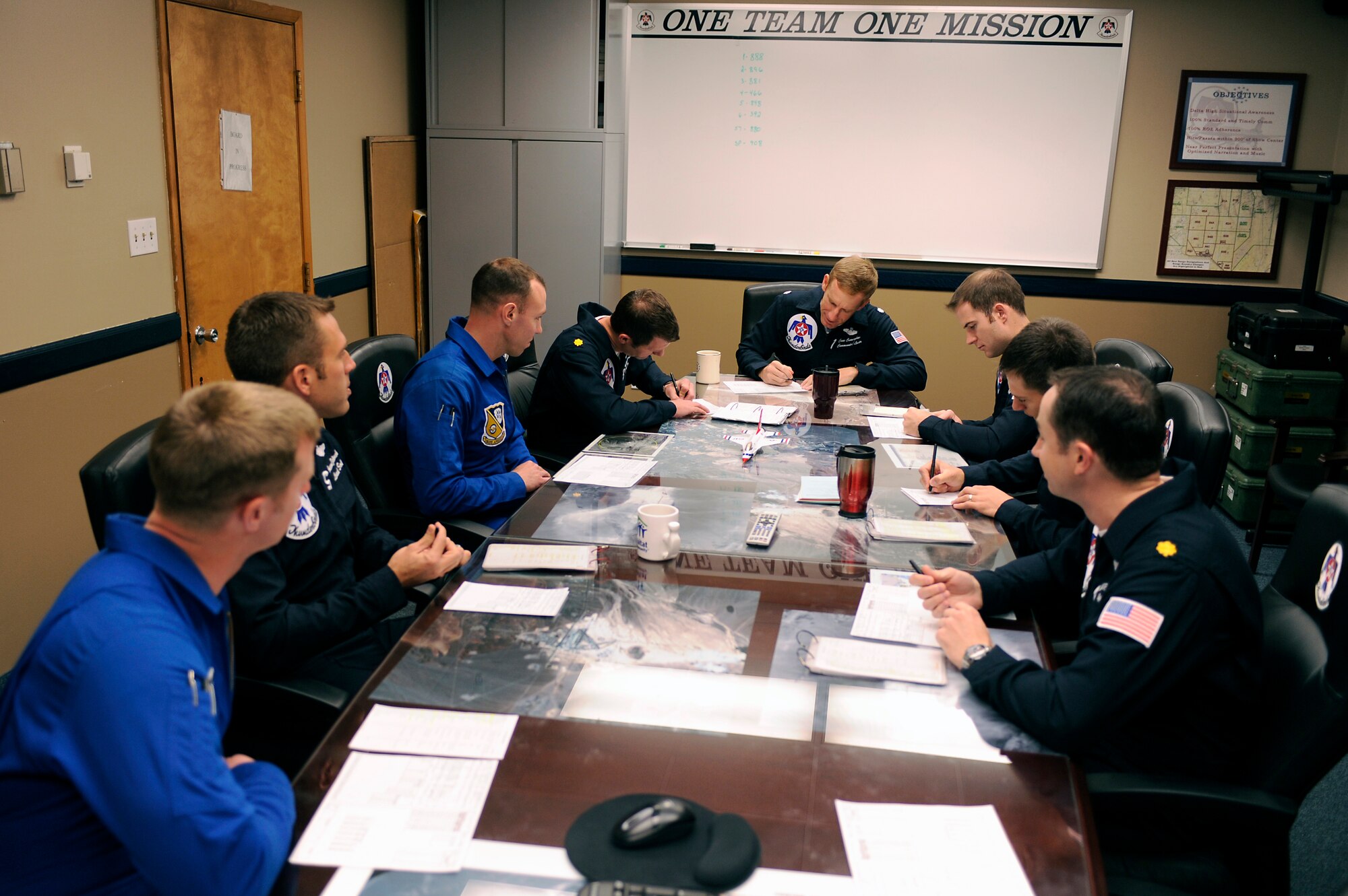 Demonstration pilots from the U.S. Air Force Air Demonstration Squadron "Thunderbirds and the U.S. Navy Blue Angels conduct a joint mission brief at the Thunderbird hangar, Nellis Air Force Base, Nev., Feb. 23, 2011.
(U.S. Air Force Photo/Staff Sgt. Richard Rose Jr.)