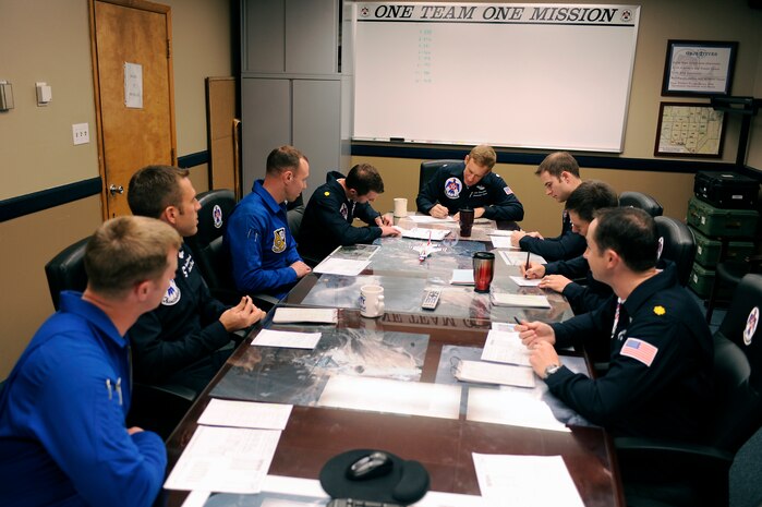 Demonstration pilots from the U.S. Air Force Air Demonstration Squadron "Thunderbirds and the U.S. Navy Blue Angels conduct a joint mission brief at the Thunderbird hangar, Nellis Air Force Base, Nev., Feb. 23, 2011.(U.S. Air Force Photo/Staff Sgt. Richard Rose Jr.)
