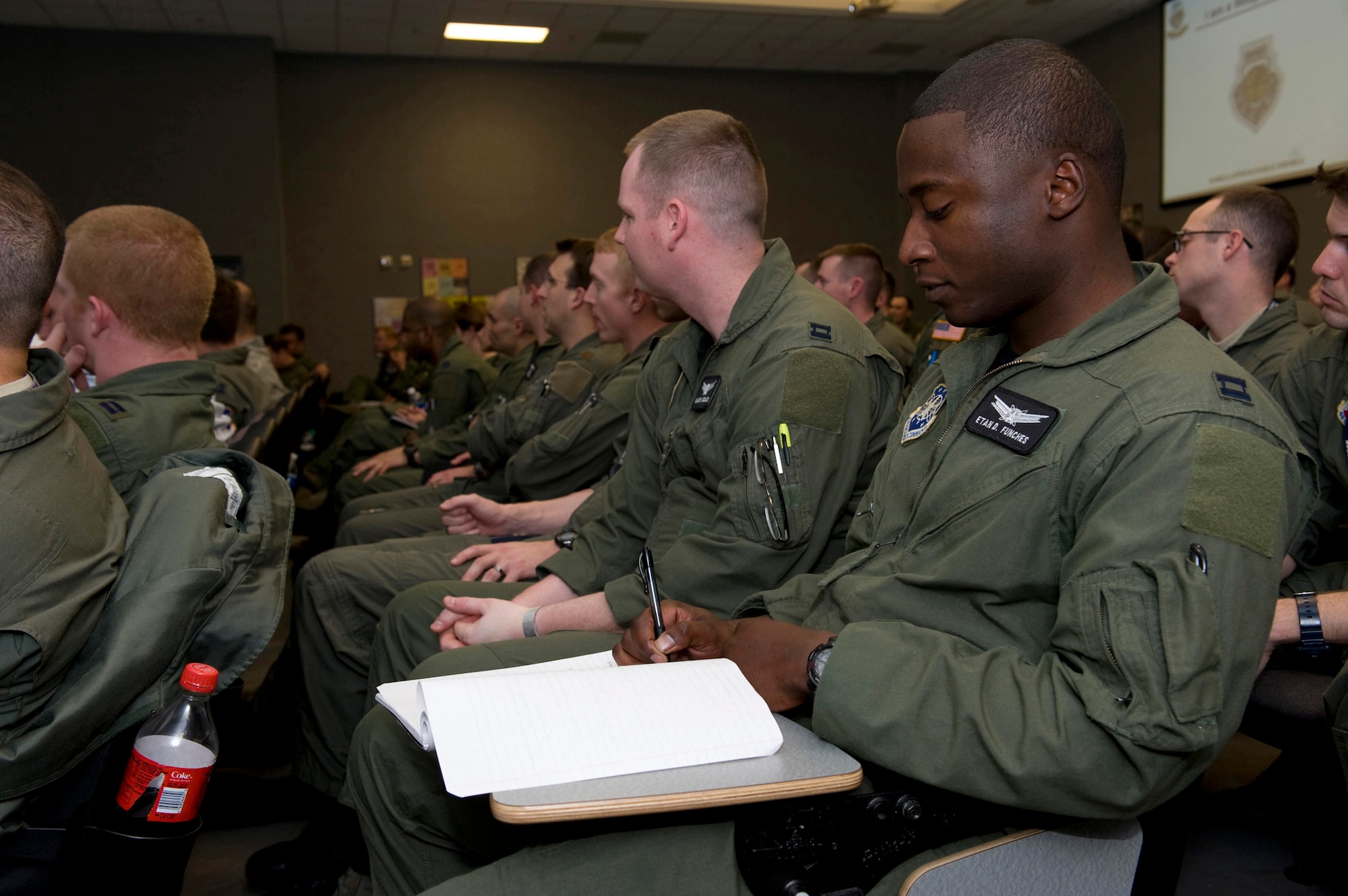 NELLIS AIR FORCE BASE, Nev. -- Capt. Etan Funches, U.S. Air Force Weapons School student, takes notes during a leadership course presented by Simon Sinek, an internationally renowned speaker and author of the book ?Start with Why: How Great Leaders Inspire Everyone to Take Action.?  Mr. Sinek helped the U.S. Air Force Weapons School develop a new curriculum focused on creating the next generation of Air Force leaders and helped introduce the program to students Feb. 22. (U.S. Air Force photo/Senior Airman Brett Clashman)