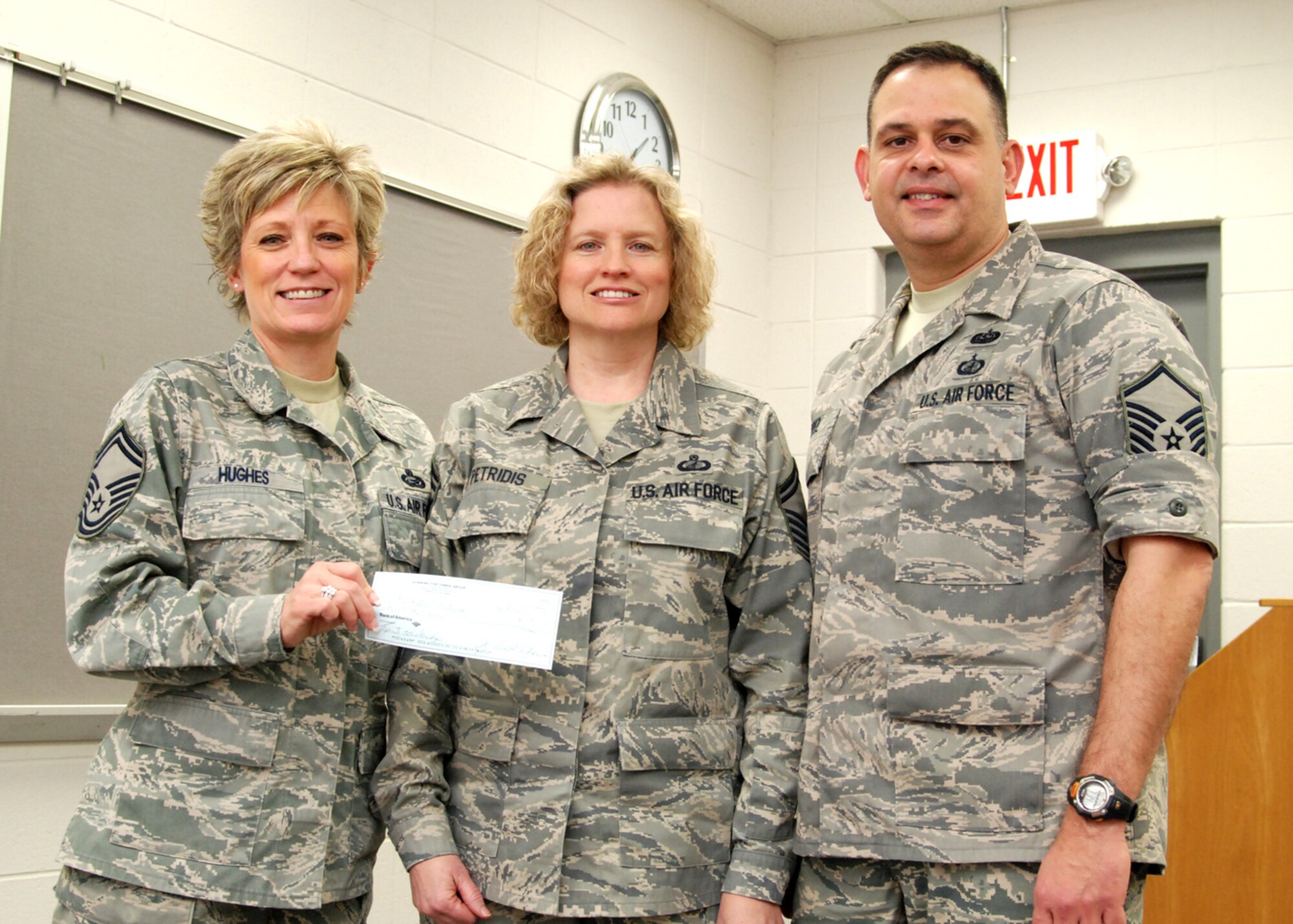 Senior Master Sgt. Joy Hughes and Master Sgt. Larry Lopez present the first  Dobbins TOP 3 Group Community College of the Air Force Scholarship Award to Senior Master Sgt. Kathleen Petridis, 94th Finance NCOIC during the February Top 3 meeting.  Sergeant Petridis was chosen for the award based on the leadership and positive attributes listed in the nomination package by her superivosr, Capt. Isidro Renteria-Silva, 94th Finance officer.   