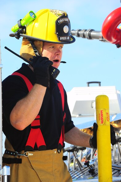 DYESS AIR FORCE BASE, Texas—Airman 1st Class Jonathon Fish, 7th Civil Engineer Squadron, communicates on a radio Feb. 22 about a fire near the cantonment area here. The fire started in a garbage truck, but was moved near the cantonment area to be safely extinguished. To report a fire at Dyess, call 911. For non-emergencies, call (325) 696-2486. (U.S. Air Force photo/Airman 1st Class Courtney Moses) 