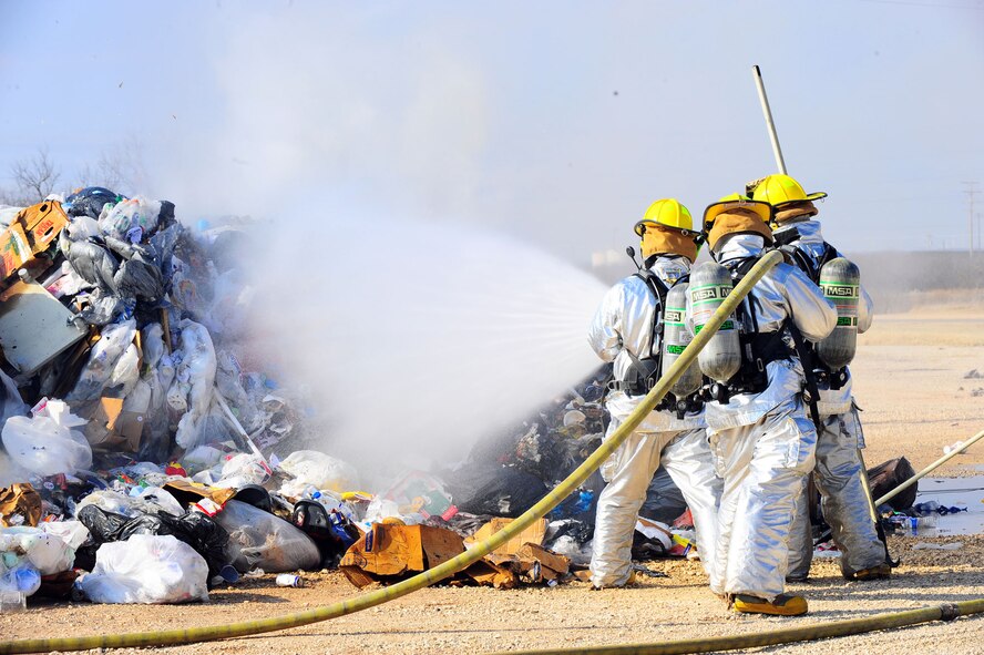DYESS AIR FORCE BASE, Texas--7th Civil Engineer Squadron firefighters put out a fire Feb. 22 near the cantonment area here. The fire started in a garbage truck, but was moved near the cantonment area to be safely extinguished. To report a fire at Dyess, call 911. For non-emergencies, call (325) 696-2486. (U.S. Air Force photo/Airman 1st Class Courtney Moses)