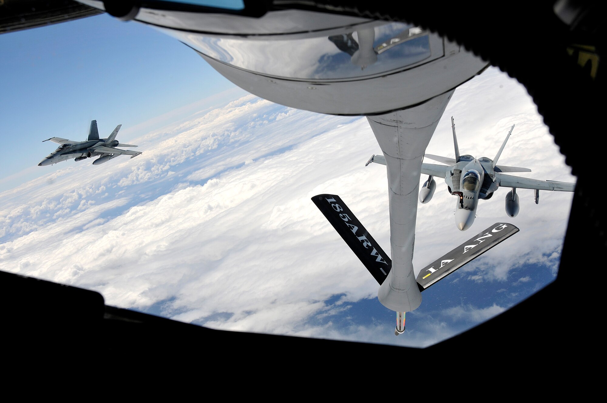 Pair of F-18 Fighter Jets from the Royal Australian Air Force, receivesfuel from a KC-135 Tanker's boom, from the 185th Air Refueling Wing (ARW) Sioux City, Iowa, Iowa Air National Guard, over the East coast of Australia, in Williamtown, New South Wales, Australia, on February 23, 2011. The 185th ARW is participating in a joint flight exercise, "Sentry Down Under", refueling F-16C and F-18 Fighter Jets in Australia.
(USAF Photo/ Tech. Sgt. Oscar M. Sanchez-Alvarez)

