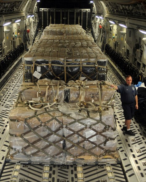 JOINT BASE CHARLESTON, S.C. -- Seven pallets of food donated by the World Missions Center sit in a C-17 Globemaster III from Altus Air Force Base, Okla., before being unloaded. The food was delivered to Managua Airport, Nicaragua in support of humanitarian operations Feb. 20. The delivery was possible because of the Denton Program, which allows donors to use space available on U.S. military cargo aircraft to transport humanitarian goods and equipment to countries in need. (U.S. Air Force photo by Airman 1st Class Kenneth W. Norman)