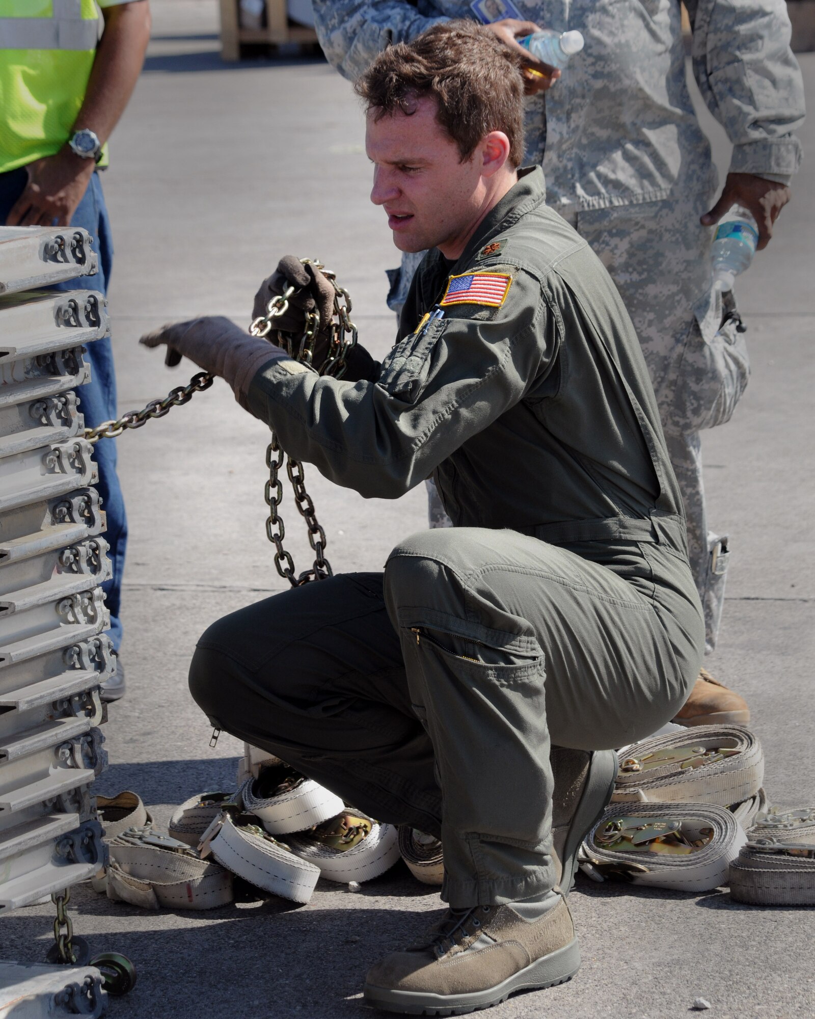JOINT BASE CHARLESTON, S.C – Maj. Matthew C. Martin, 58th Airlift Squadron, Altus Air Force Base, Okla., helps secure empty pallets at Port-au-Prince Airport, Haiti, Feb. 19. The crew from the 58th AS delivered 10 pallets of building materials and food in support of relief operations in Haiti. The delivery was possible because of the Denton Program, which allows donors to use space available on U.S. military cargo aircraft to transport humanitarian goods and equipment to countries in need. (U.S. Air Force photo by Airman 1st Class Kenneth W. Norman)