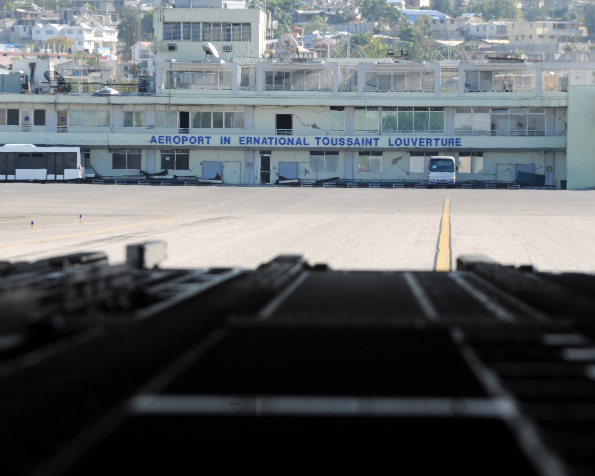 JOINT BASE CHARLESTON, S.C. -- The airport sign at Port-au-Prince, Haiti, can be seen from the back of a C-17 Globemaster III hailing from Altus AFB. A crew from the 58th Airlift Squadron delivered building materials and food in support of relief operations in Haiti, Feb.19. The delivery was possible because of the Denton Program, which allows donors to use space available on U.S. military cargo aircraft to transport humanitarian goods and equipment to countries in need. (U.S. Air Force photo by Airman 1st Class Kenneth W. Norman)