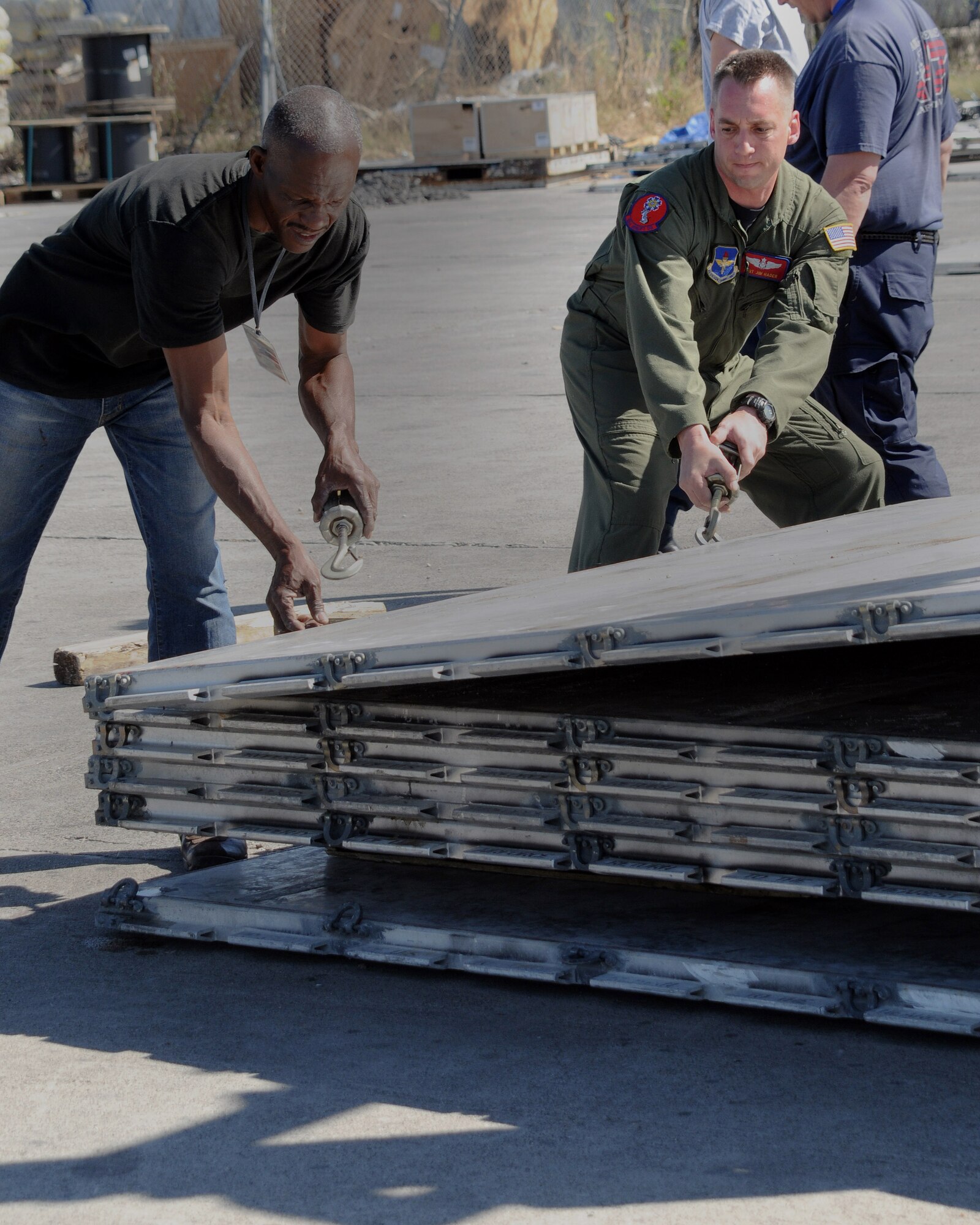 JOINT BASE CHARLESTON, S.C. -- Tech. Sgt. Jim Hader, 58th Airlift Squadron loadmaster, Altus Air Force Base, Okla., helps stack empty pallets at Port-au-Prince Airport, Haiti, Feb. 19th. The crew from the 58th AS delivered 10 pallets of building materials and food in support of relief operations in Haiti. The delivery was possible because of the Denton Program, which allows donors to use space available on U.S. military cargo aircraft to transport humanitarian goods and equipment to countries in need. (U.S. Air Force photo by Airman 1st Class Kenneth W. Norman)